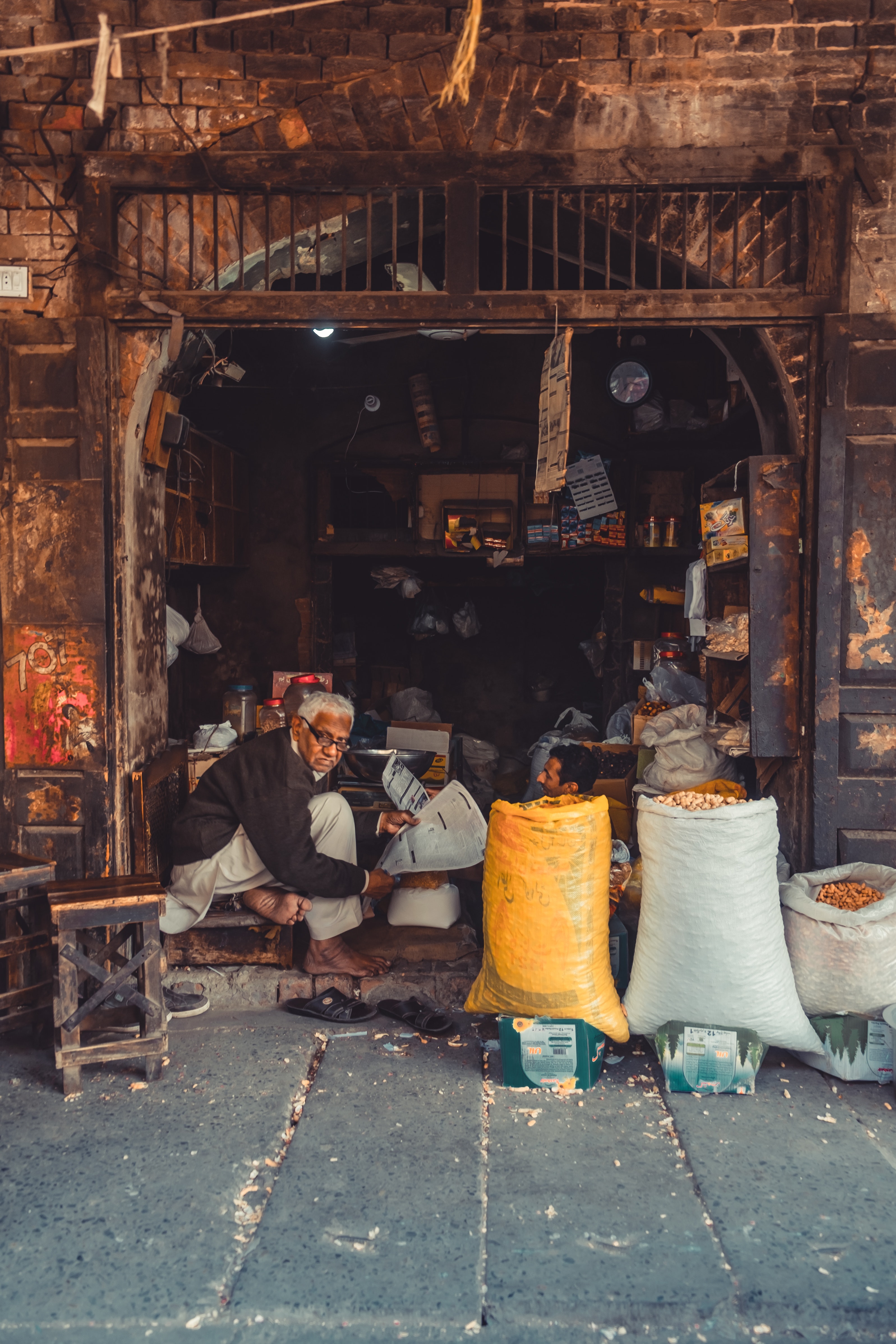 man sitting outside shop